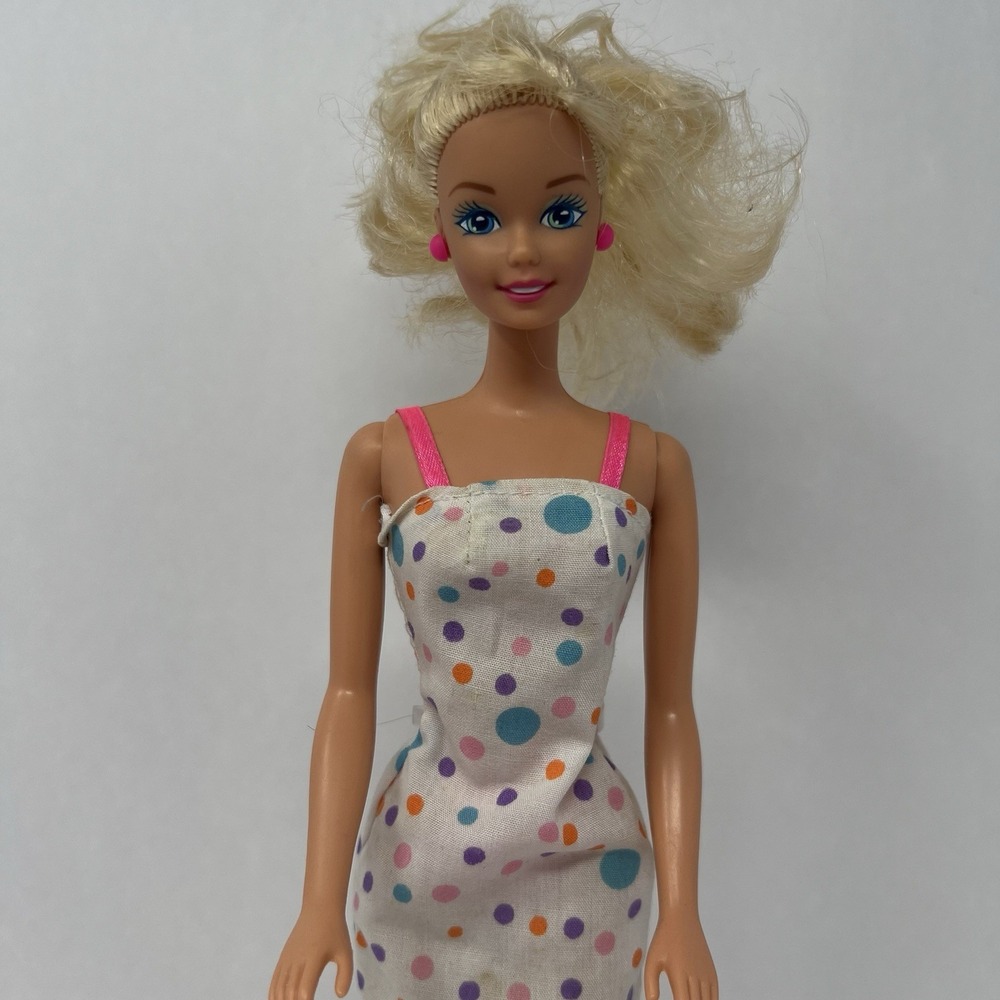 Barbie Doll Twist N Turn Blue Eyes 1966-1976 in White Colorful dotted dress.